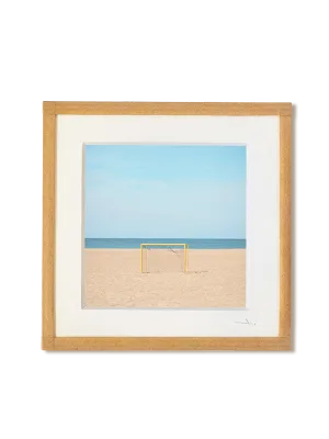 tirage photo petit format encadré à la main représentant un but de foot jaune sur le sable face à la mer